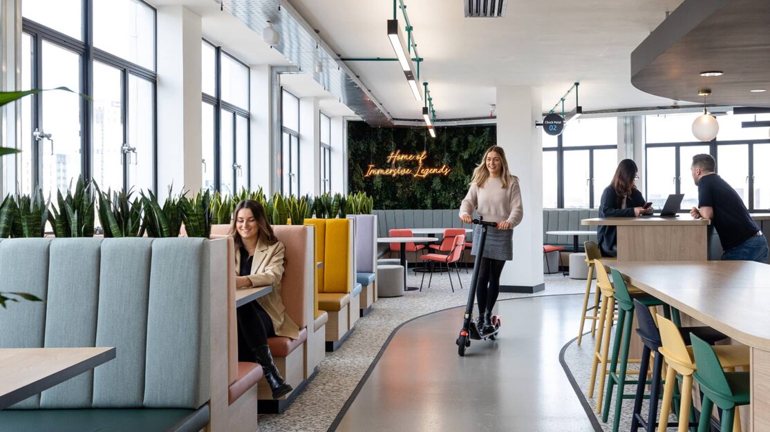 Employee on a scooter in an Interaction designed office